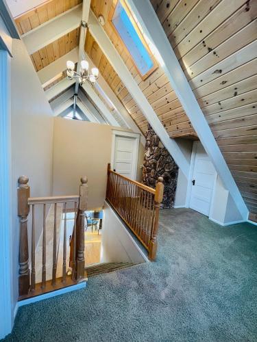 an attic hallway with a staircase and a stone wall at Lake Tapps Dock House on the Bankers Island in Dieringer
