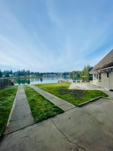 a walkway next to a lake with a building at Lake Tapps Dock House on the Bankers Island in Dieringer