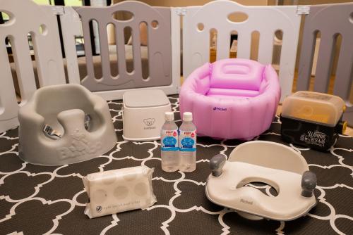a toy crib with a baby bottle and other toys at Rakuten STAY Nikko Hoden in Nikko
