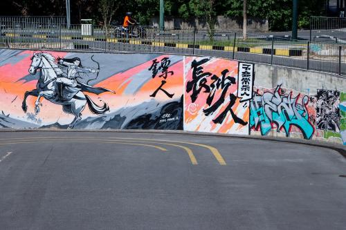 a wall with a mural of a man riding a horse at Holiday Inn Express Changsha Development Zone by IHG in Xingsha