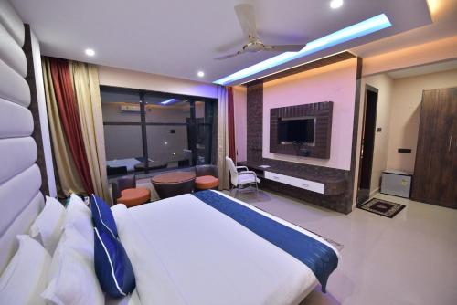 a hotel room with a bed and a television at Hotel Himalaya in Bongaigaon