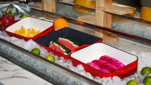 two trays of food on a counter with ice at VM Hotel in Phnom Penh