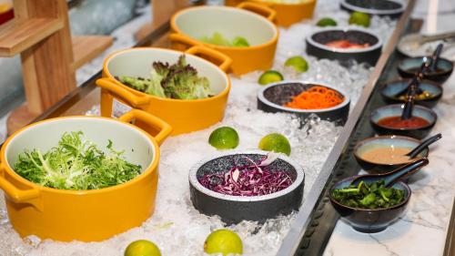 a table topped with buckets of vegetables and snow at VM Hotel in Phnom Penh