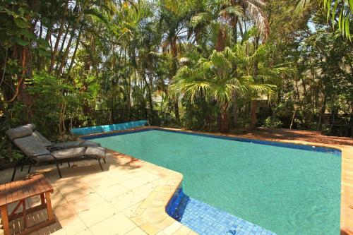 a swimming pool with a bench and a chair next to it at Stay 4 night Pay 3 nights nights only during March 2026 in Alexandra Headland