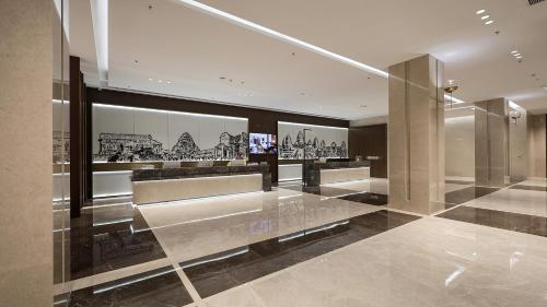 a lobby of a building with pictures on the wall at VM Hotel in Phnom Penh