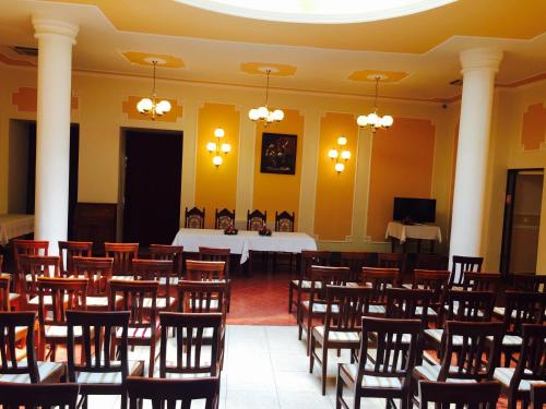 a room with rows of chairs and a table at Hotel Astoria in Satu Mare
