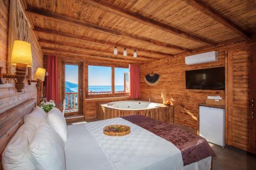 een slaapkamer met een bed en een bad bij Ölüdeniz Manzara Non Alcoholic Family Hotel in Oludeniz