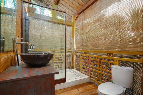 a bathroom with a sink and a toilet at Villa Pagoda, Sumptuous 4BR Villa with Tropical Vibes in Seminyak in Legian