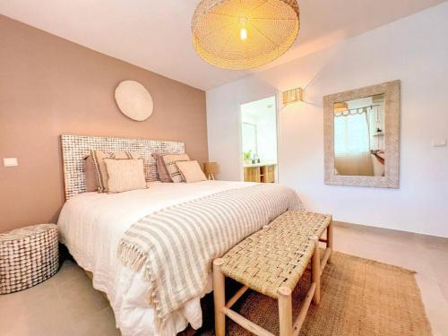 a bedroom with a large bed and a mirror at Dolce Riviera, Beach Access, Pool View, 2 Bedrooms in Anse Marcel 