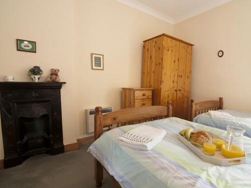 a bedroom with a bed with a tray of food on it at 2 bed property in Wooler Northumberland CN226 in Wooler