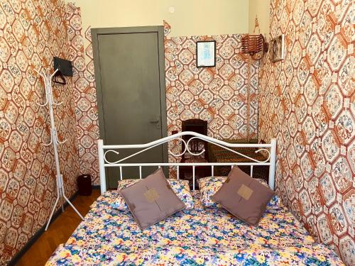 a bedroom with a bed with two pillows on it at Lets Go House in Tbilisi City