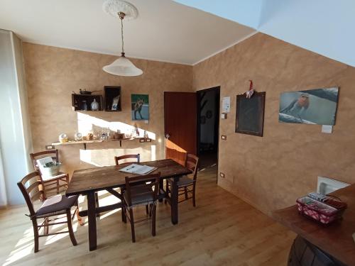 a dining room with a wooden table and chairs at LA ROCCA BIANCA in Demonte