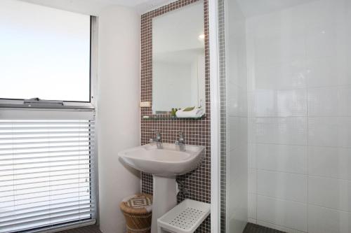 a bathroom with a sink and a mirror at Syrenuse 22 in Mooloolaba