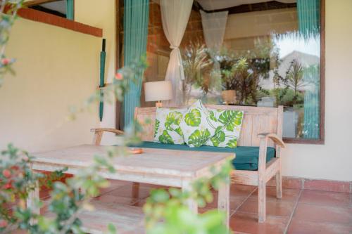 a living room with a couch and a table at Taman Sari Bali Resort and Spa in Pemuteran