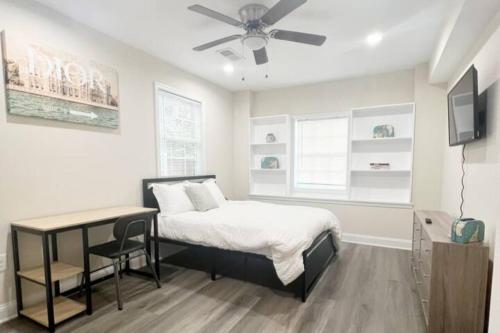a bedroom with a bed and a ceiling fan at The Traveler - Your Private Retreat, Inspired by the Spirit of Travel in Manassas Park