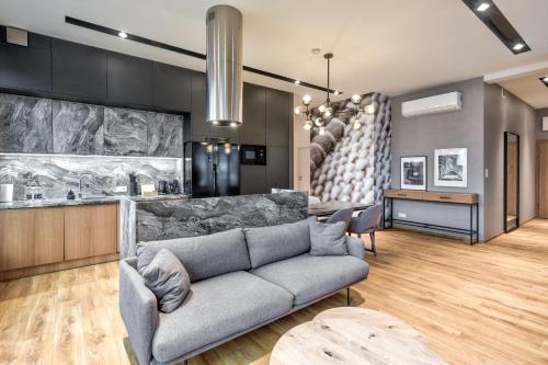 a living room with a couch and a kitchen at Cotton House in Łódź