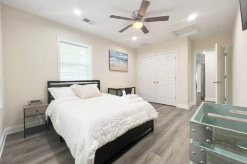 a bedroom with a bed and a ceiling fan at The Beach Pad - Your Private Oasis with a Cool Beachy Vibe in Manassas Park