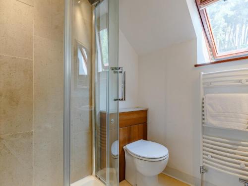 a bathroom with a toilet and a glass shower at 3 Bed in Gratton 78618 in Youlgreave