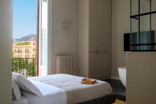 a bedroom with a bed and a large window at Palermo al Massimo in Palermo