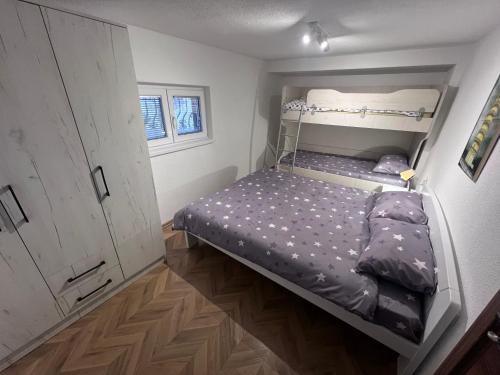 a small bedroom with a bunk bed in it at Mavrovo Square " Villas & Apartment " in Mavrovo