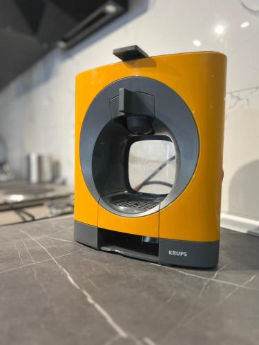 a orange and black appliance sitting on a counter at Mavrovo Square " Villas & Apartment " in Mavrovo