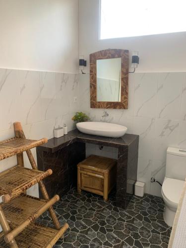 a bathroom with a sink and a mirror at Gili Davidoff Bungalow in Gili Trawangan