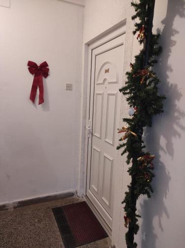 a door with a bow and a christmas ornament at Apartman Luka in Kupres