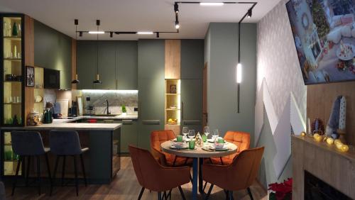 a kitchen with a table and chairs in a kitchen at Pinewood ANG premium luxurious apartment 15 in Borovets