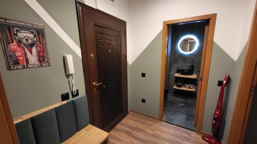 a hallway with a dog picture on the wall next to a door at Pinewood ANG premium luxurious apartment 15 in Borovets