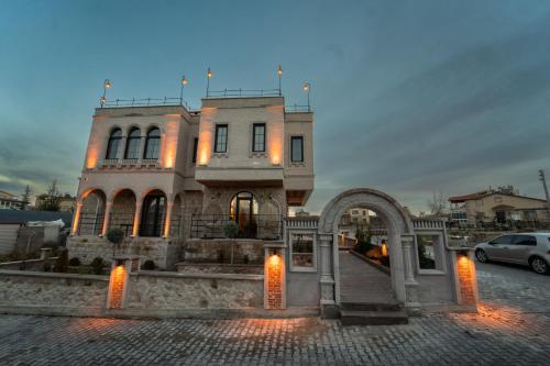 a large building with lights in front of it at Alin Stone House in Uchisar