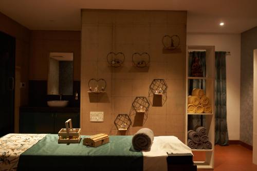 a room with a bed with items on it at Ikshana Resort and Spa, Khandala in Lonavala