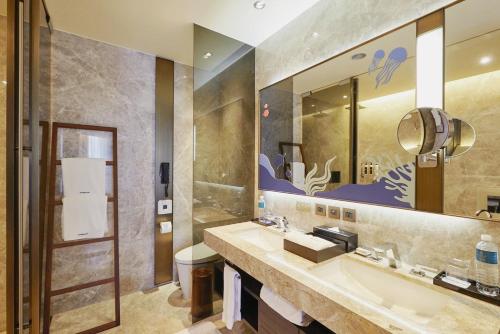 a bathroom with a sink and a mirror at Madison Taipei Hotel in Taipei