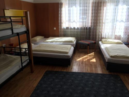 a room with four bunk beds and a window at Jugendhotel Nürnberg in Nürnberg