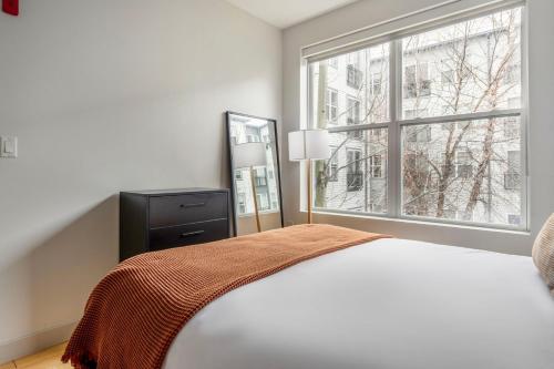 a white bedroom with a bed and a window at South Boston 1br w gym nr red line shops BOS-984 in Boston