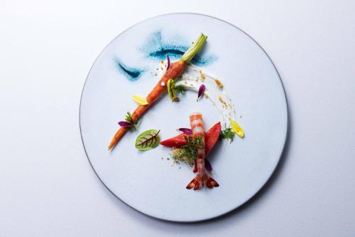 a plate with carrots and other vegetables on it at Hotel Okura Kyoto Okazaki Bettei in Kyoto