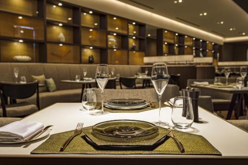 a table in a restaurant with plates and wine glasses at Hotel Okura Kyoto Okazaki Bettei in Kyoto