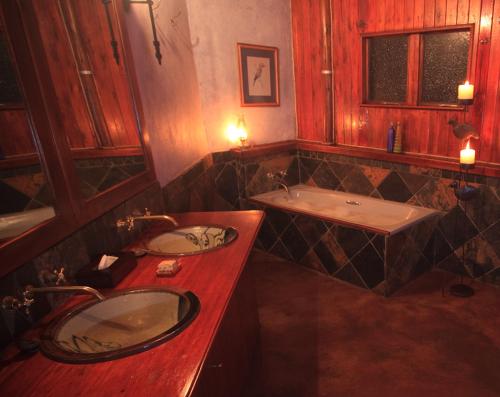 a bathroom with a sink and a bath tub at Shayamoya Tiger Fishing and Game Lodge in Pongola Game Reserve