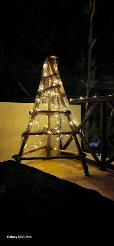 a glass christmas tree with lights in the snow at Ayla Beach House in Kiwengwa