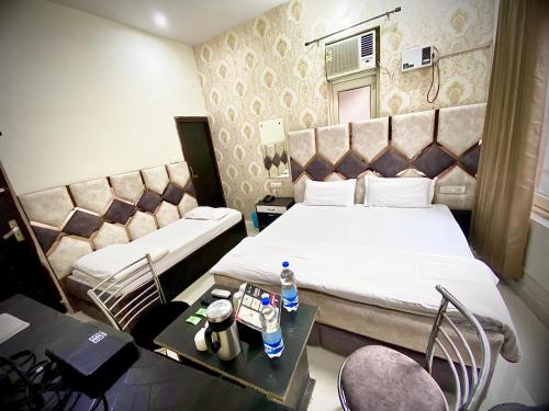 a small hotel room with a bed and a table at Swaran hotel in Amritsar