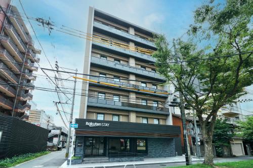 an apartment building with a sign in front of it at Rakuten STAY Kokura Station in Kitakyushu