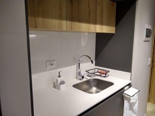 a kitchen with a sink and a counter top at Casa Juanito Coworking El Nogal in Zona Rosa in Bogotá
