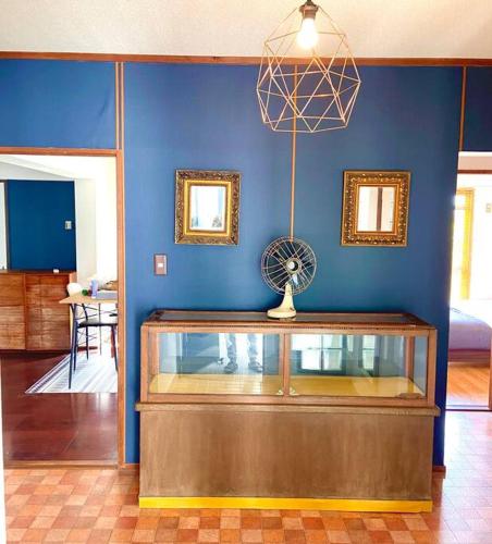 a room with a blue wall with a glass table and a fan at sonic apartment annex202　sonic hotelの離 ４名様まで同一価格 in Dazaifu