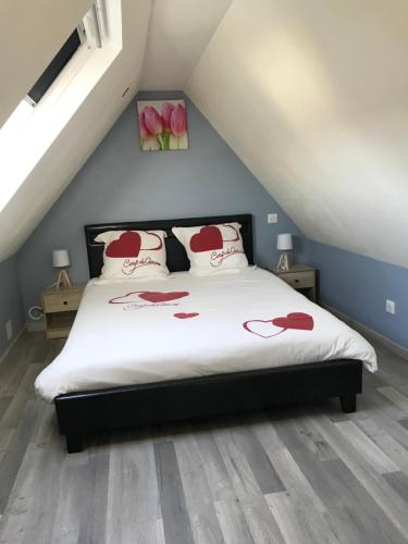 Un dormitorio con una cama con flores rojas. en Jolie maisonnette, en Auxerre