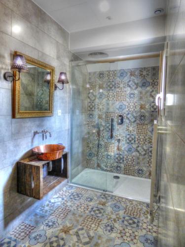 a bathroom with a sink and a shower at Le Moulin de Follet in Fougeré