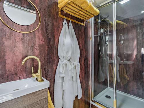 a bathroom with a shower and a sink and a mirror at 1 Bed in Kinlochleven 87131 in Kinlochleven