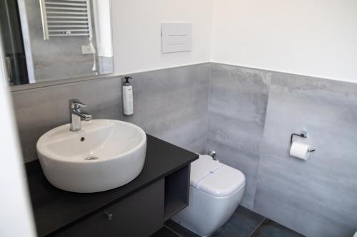 a bathroom with a sink and a toilet at Palazzo Cappuccini Art Relais in Naples
