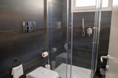 a bathroom with a shower and a toilet at Palazzo Cappuccini Art Relais in Naples
