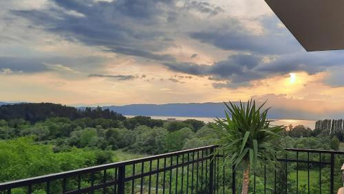 a balcony with a view of the water and trees at Villa Marta Green in Ohrid