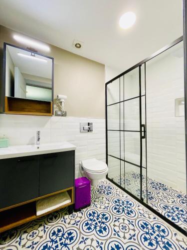 a bathroom with a toilet and a sink and a mirror at Puffin Boutique - Istanbul in Istanbul