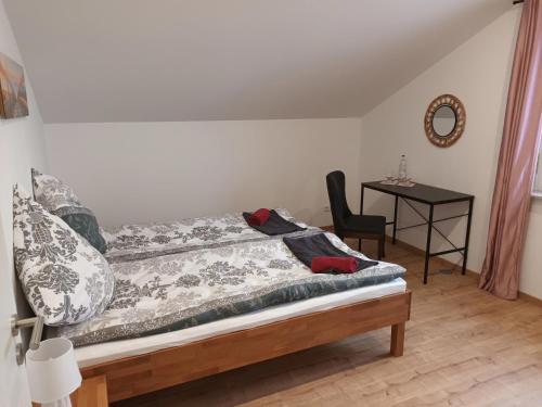 1 dormitorio con 1 cama con silla y mesa en Waldblick, 